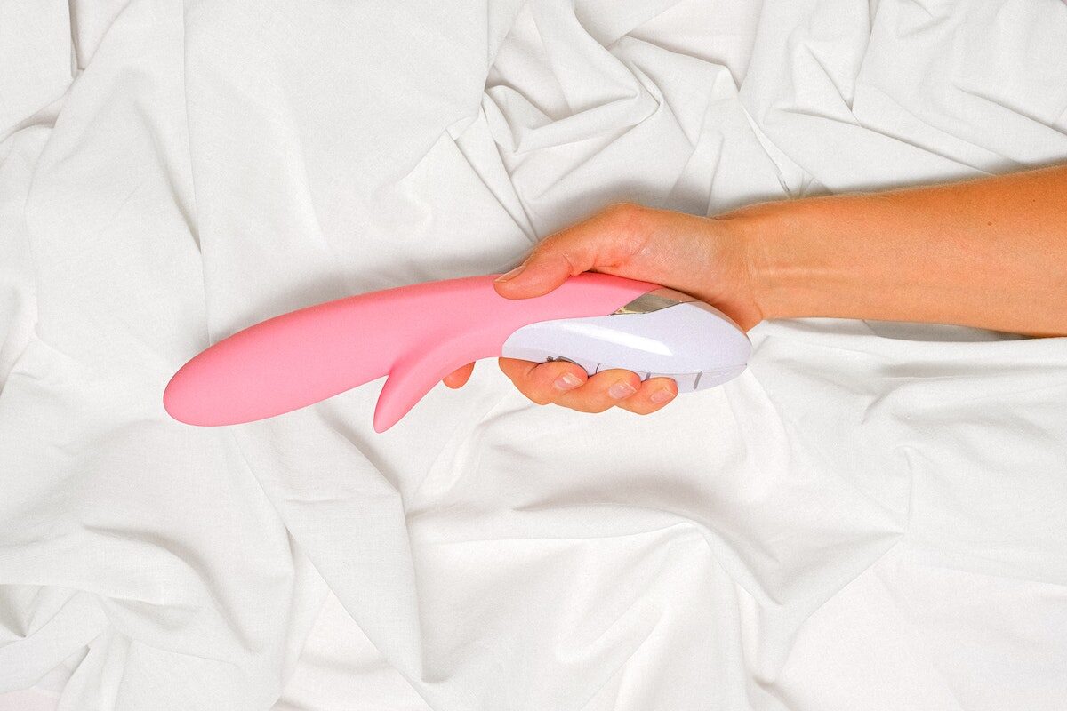 Person Holding a Pink Vibrator