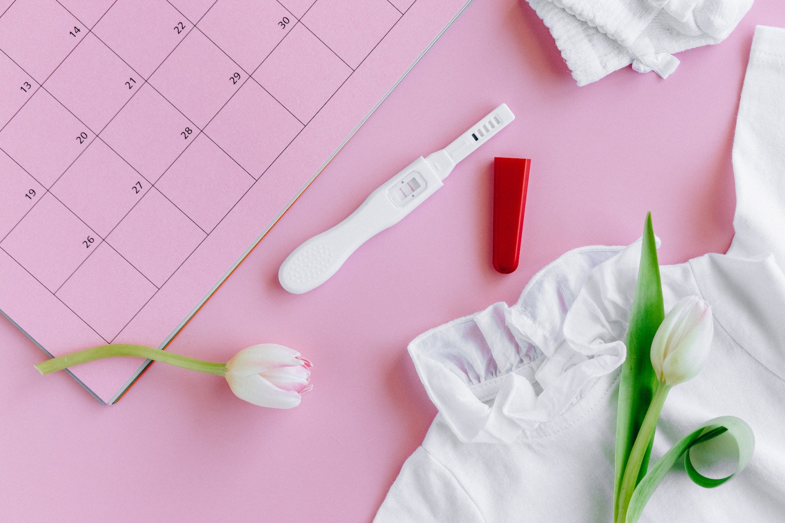 White Pregnancy Test Kit beside White Shirt